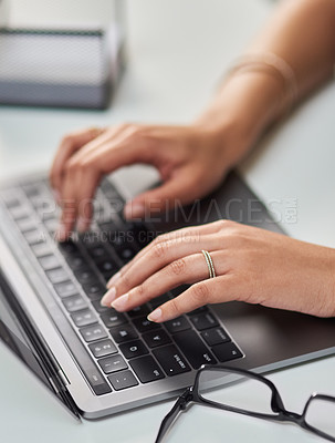 Buy stock photo High angle shot of an unrecognizable businesswoman working on a laptop in her office