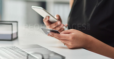 Buy stock photo Cropped shot of an unrecognizable businesswoman making a credit card payment using a mobile phone