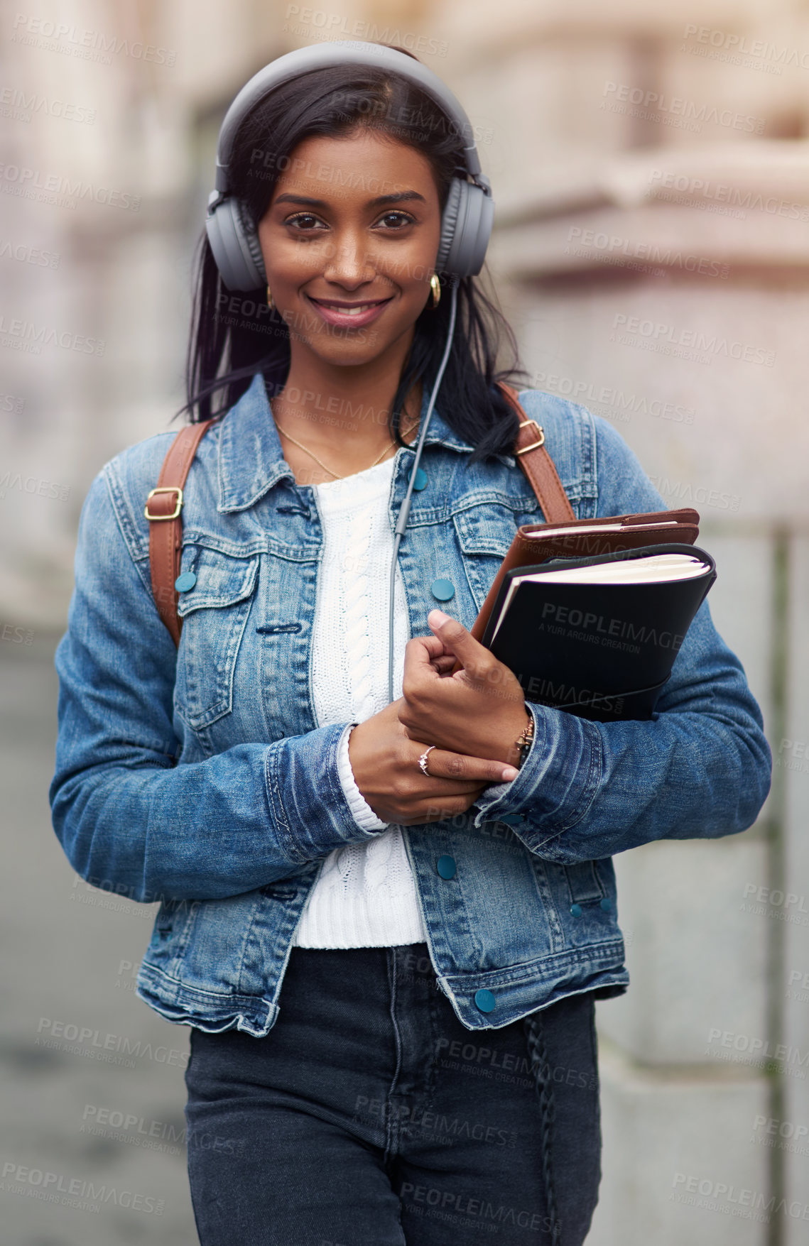 Buy stock photo City, books and portrait of student with headphones for education, travel and music on commute to campus. University, Indian girl and journal with technology for learning, journey and audio streaming