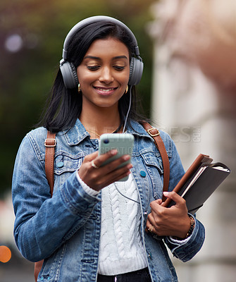 Buy stock photo Happy woman, student and listening with phone in city for music, audio or outdoor streaming. Female person or Indian walking with smile on mobile smartphone for podcast or elearning in an urban town