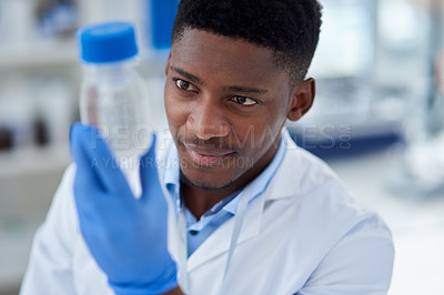 Buy stock photo Science, research and black man with container, chemical or medical engineering in laboratory. Biotech, scientist or lab technician with liquid solution in vaccine study for pharmaceutical innovation
