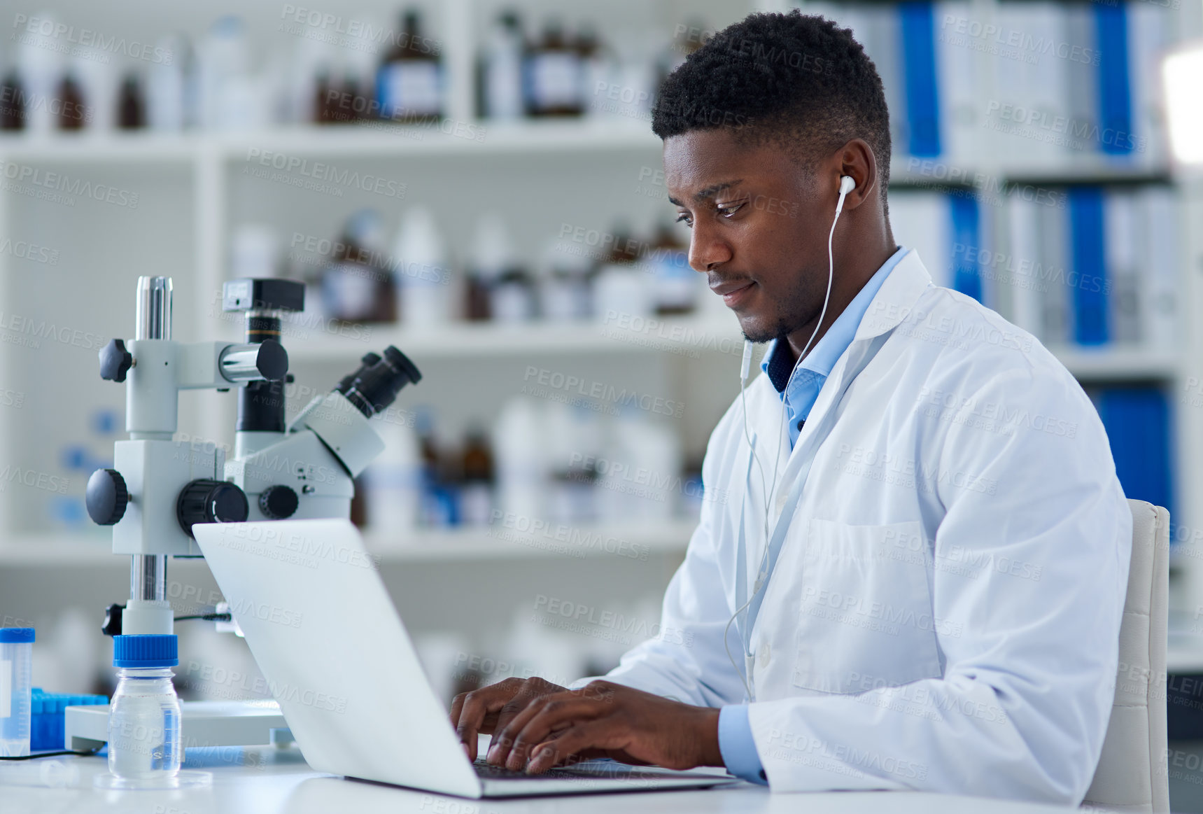 Buy stock photo Science, man and laptop in lab with research for medical study, microscopic experiment or DNA testing with earphones. Scientist, african expert and happy for gene editing and healthcare breakthrough