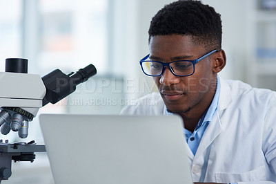 Buy stock photo Science, man and laptop in lab with research for medical research, microscopic experiment or DNA testing with glasses. Scientist, african expert or serious for gene editing or healthcare breakthrough