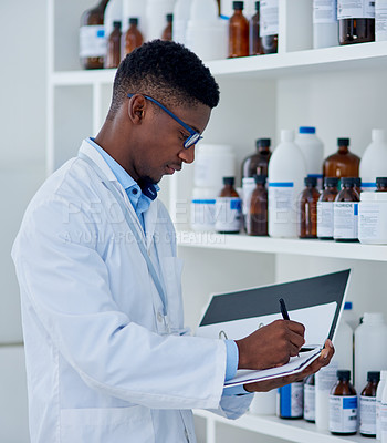 Buy stock photo Black man, scientist and folder for inventory in lab for medical stock, update and products checklist. Doctor writing, pharmacist or bottles with chemical supply for research on paper or report
