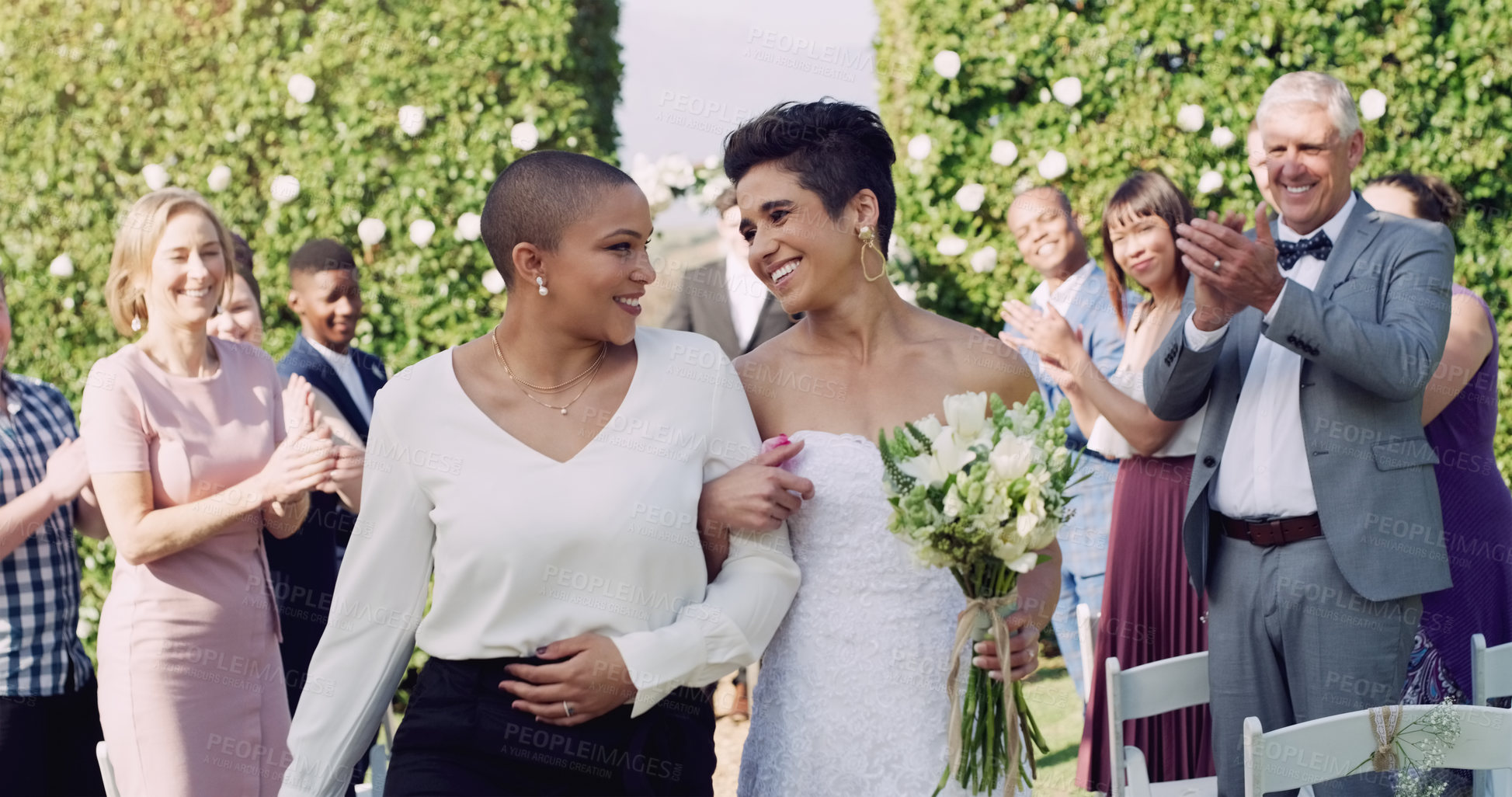 Buy stock photo Wedding, happiness and interracial lesbian couple walking down aisle with smile, love and applause. Lgbt marriage, celebration and happy women at ceremony or reception with lgbtq pride and commitment