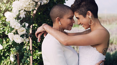 Buy stock photo Love, hug and lgbtq with lesbian couple at wedding for celebration, gay and pride. Smile, spring and happiness with women kiss at marriage event for partner commitment, sexuality and freedom