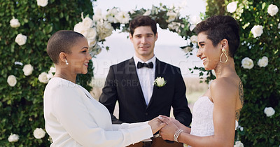 Buy stock photo Love, holding hands and smile with lesbian couple at wedding for celebration, gay and pride. Lgbtq, spring and happiness with women at marriage event for partner commitment, care and freedom
