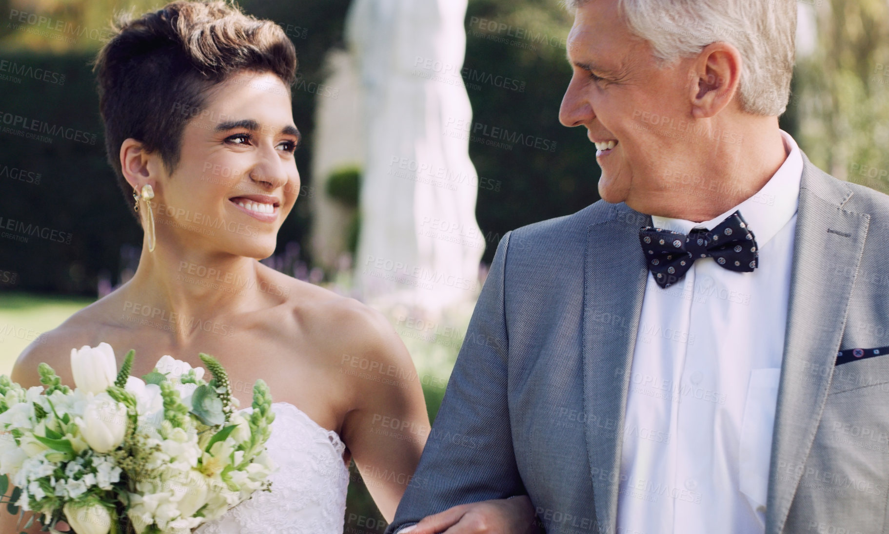 Buy stock photo Cropped shot of an affectionate mature father smiling at his daughter while walking her down the while on her wedding day