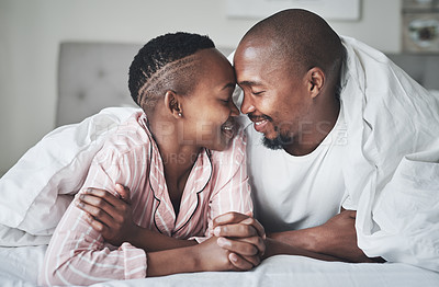 Buy stock photo Love, relax and black couple lying in bed in a hotel for valentines day, anniversary or romance. Intimacy, happy and young African man and woman relaxing in bedroom while on romantic vacation or trip