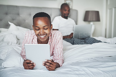 Buy stock photo Black woman with tablet, relax in bed with technology and streaming online, website subscription and wifi. Man with laptop, couple happy at home with tech, social media and internet connectivity