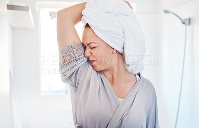 Buy stock photo Cropped shot of a young woman smelling her armpits