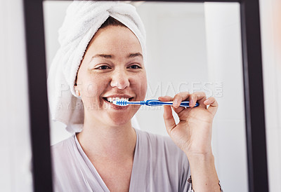 Buy stock photo Cropped shot of a beautiful woman brushing her teeth at home