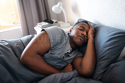 Buy stock photo Sleeping, tired and black man in bed for morning for resting, dreaming and nap in home. House, bedroom and African person comfortable with duvet, pillow and blanket for relaxing on bed on weekend