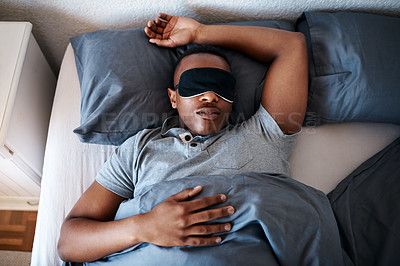 Buy stock photo Bed, sleep and black man in home with mask on eyes, peace and calm weekend morning with tired head on pillow. Relax, rest and exhausted person in bedroom with dream, fatigue and comfort in apartment