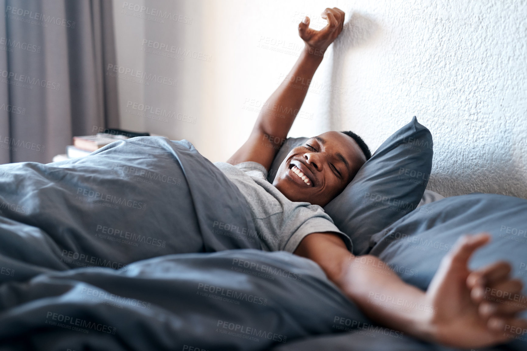 Buy stock photo Wake up, happy and black man on bed in morning for relaxing, resting and sleeping in bedroom. Apartment, house and person with smile, blanket and comfortable for health, peace and calm for nap