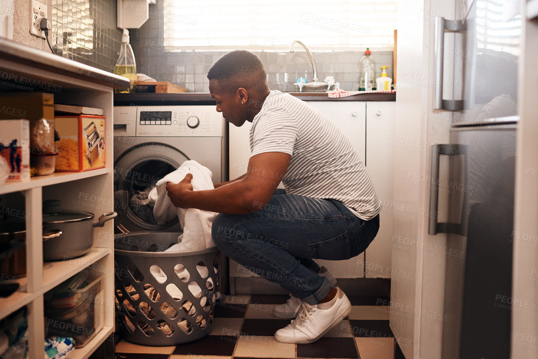 Buy stock photo Shot of a man doing the laundry at home