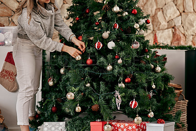 Buy stock photo Christmas, tree decorating and woman in home, celebration or living room, house and celebrate event, party or presents. Closeup hands, winter holiday time and festive ornament, xmas lights and lounge