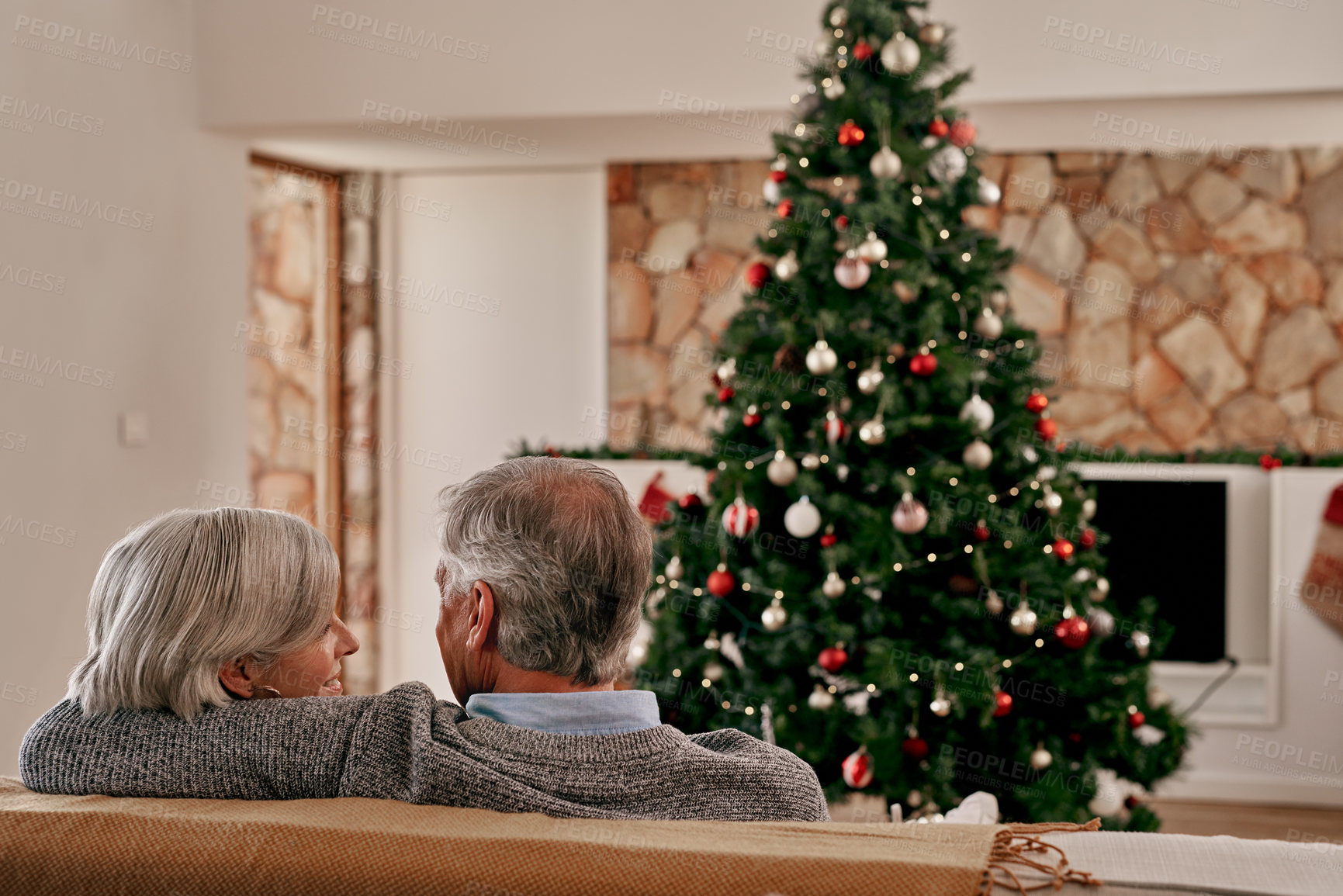 Buy stock photo Elderly couple, hug and relax on sofa by Christmas tree for relationship bonding or quality time together at home. Senior man holding woman on living room couch for holiday, vacation or new year