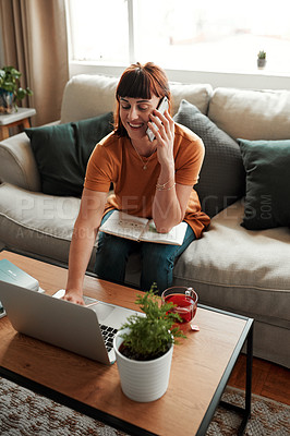 Buy stock photo Shot of a woman talking on her cellphone while using her laptop at home