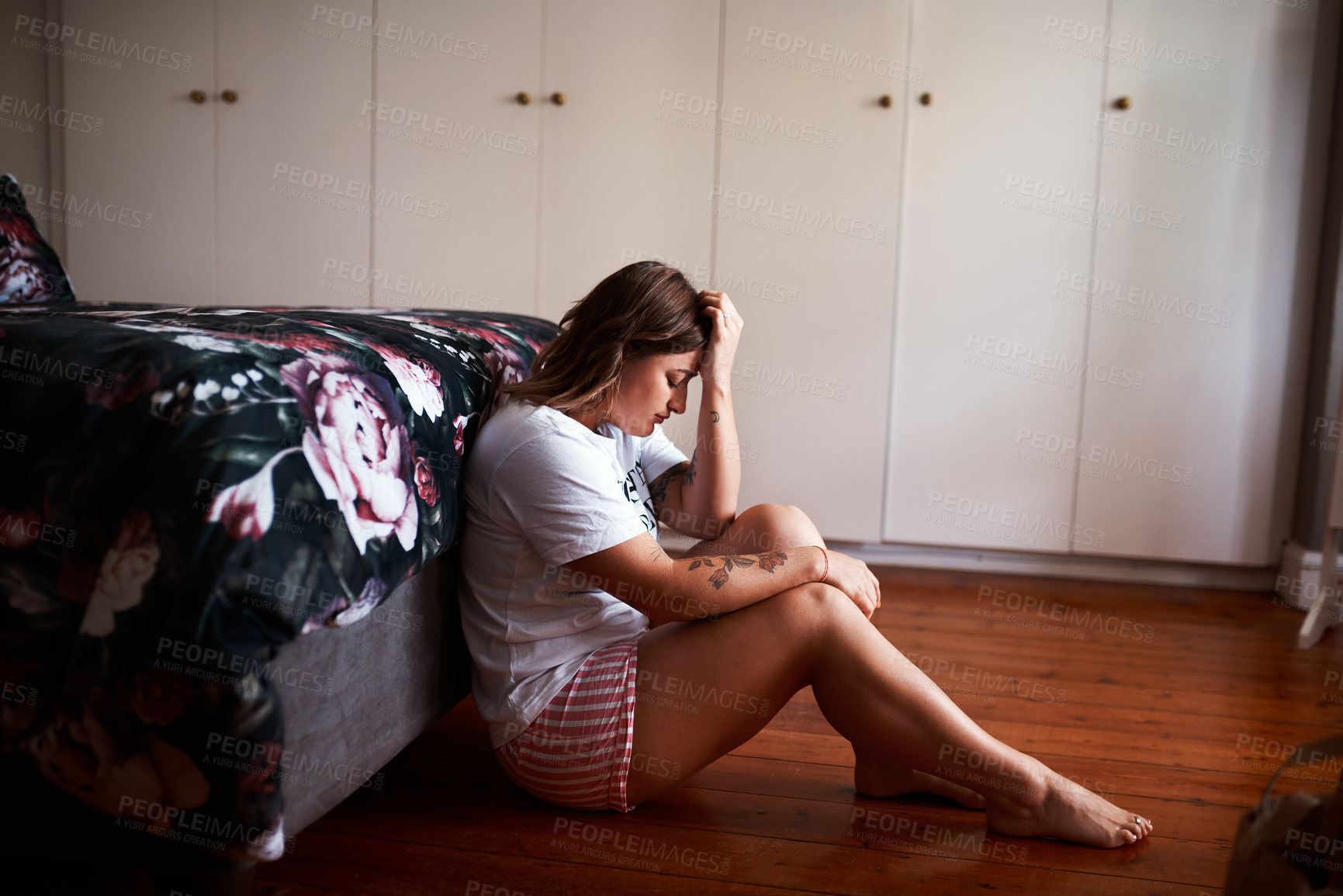 Buy stock photo Woman, home and upset in bedroom on floor with stress, worry or mental health problem. Female person, apartment and sad or angry with depression, anxiety and tired on psychological trauma or emotions