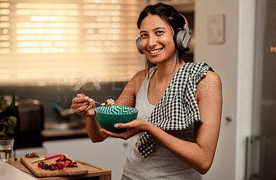 Buy stock photo Headphones, eating breakfast and portrait of woman in kitchen with strawberry. Face headphone, food and happy female person with healthy fruit while listening to audio music, sound or radio podcast.