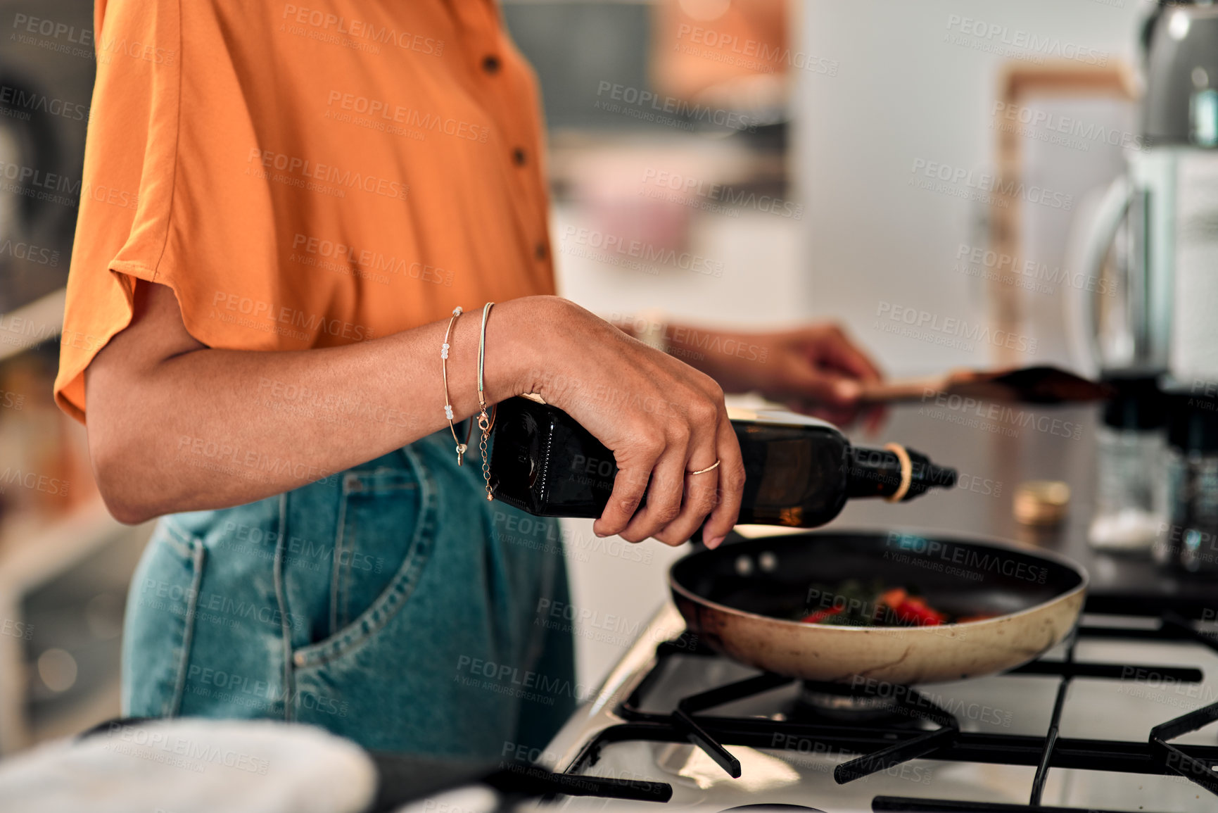 Buy stock photo Hands, cooking and olive oil with a woman in the kitchen of her home for food or meal preparation. Stove, pan and container with a female chef in her house to cook for health, diet or nutrition