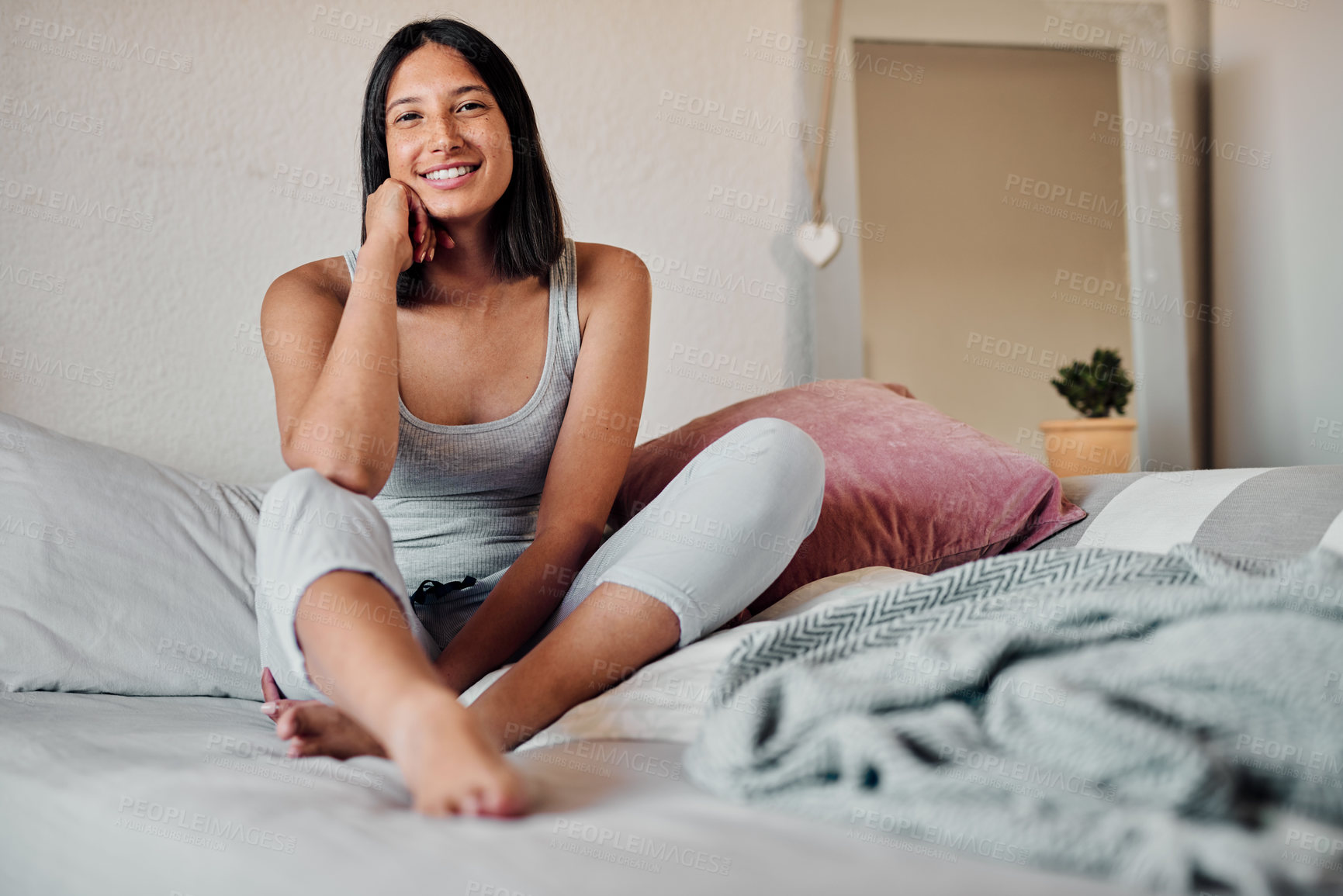 Buy stock photo Shot of a young woman relaxing on her bed in the morning at home