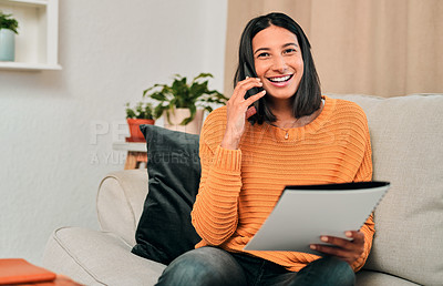 Buy stock photo Shot of a young woman using a smartphone while working on the sofa at home