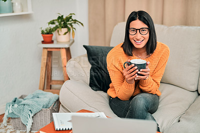 Buy stock photo Shot of a young woman having a coffee break while working on the sofa at home