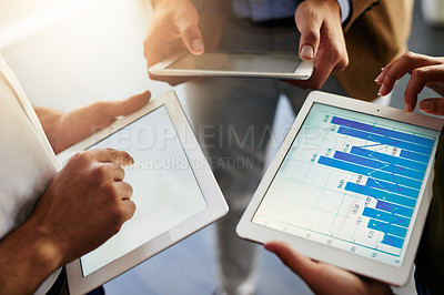 Buy stock photo Cropped shot of unrecognizable businesspeople using their digital tablets