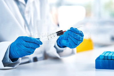 Buy stock photo Closeup shot of an unrecognisable scientist using a syringe while working in a lab
