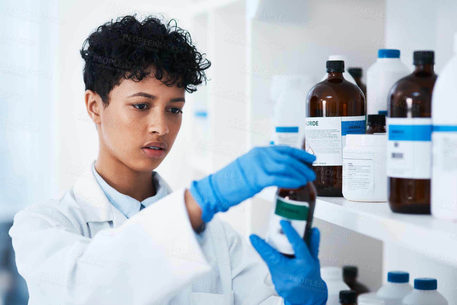Buy stock photo Shot of a young scientist working with chemical substances in a lab