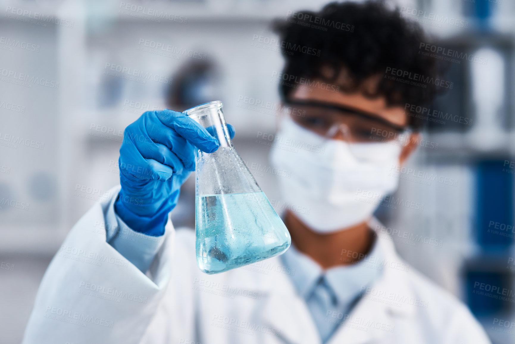 Buy stock photo Closeup shot of a young scientist holding a beaker in a lab