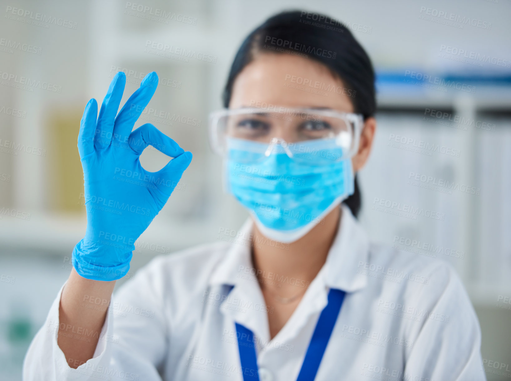 Buy stock photo Portrait of a confident young woman making an okay gesture in a laboratory