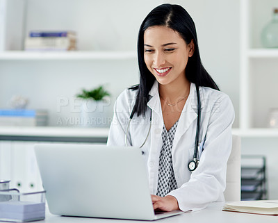Buy stock photo Shot of a young doctor using a laptop at her desk