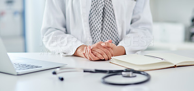Buy stock photo Cropped shot of an unrecognizable doctor working at her desk