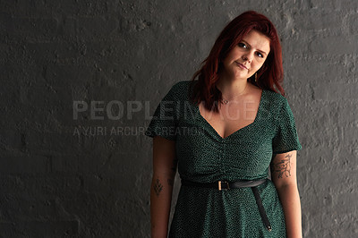 Buy stock photo Cropped shot of a beautiful young woman posing against a grey wall