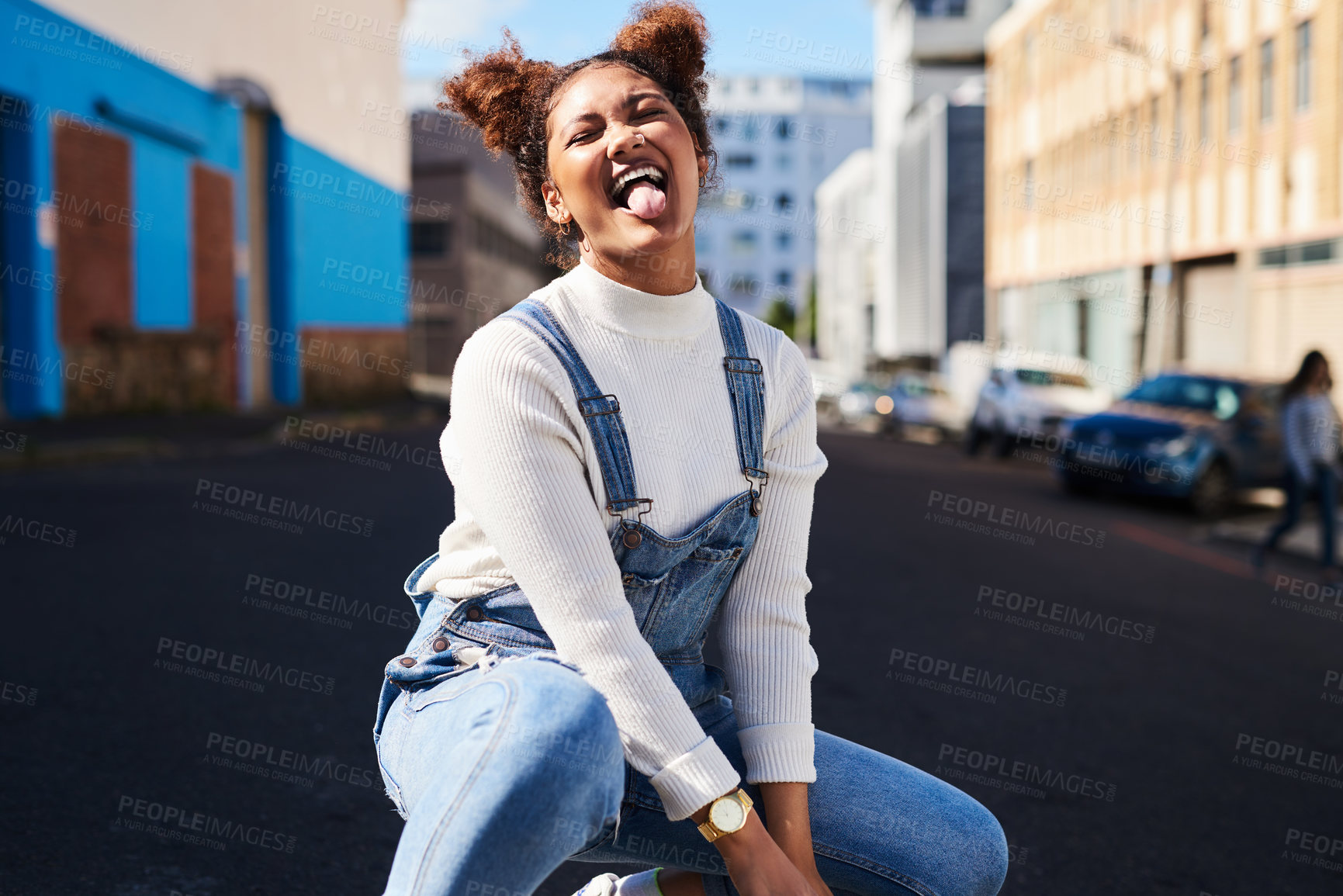 Buy stock photo Shot of a playful young woman out in the city during the day