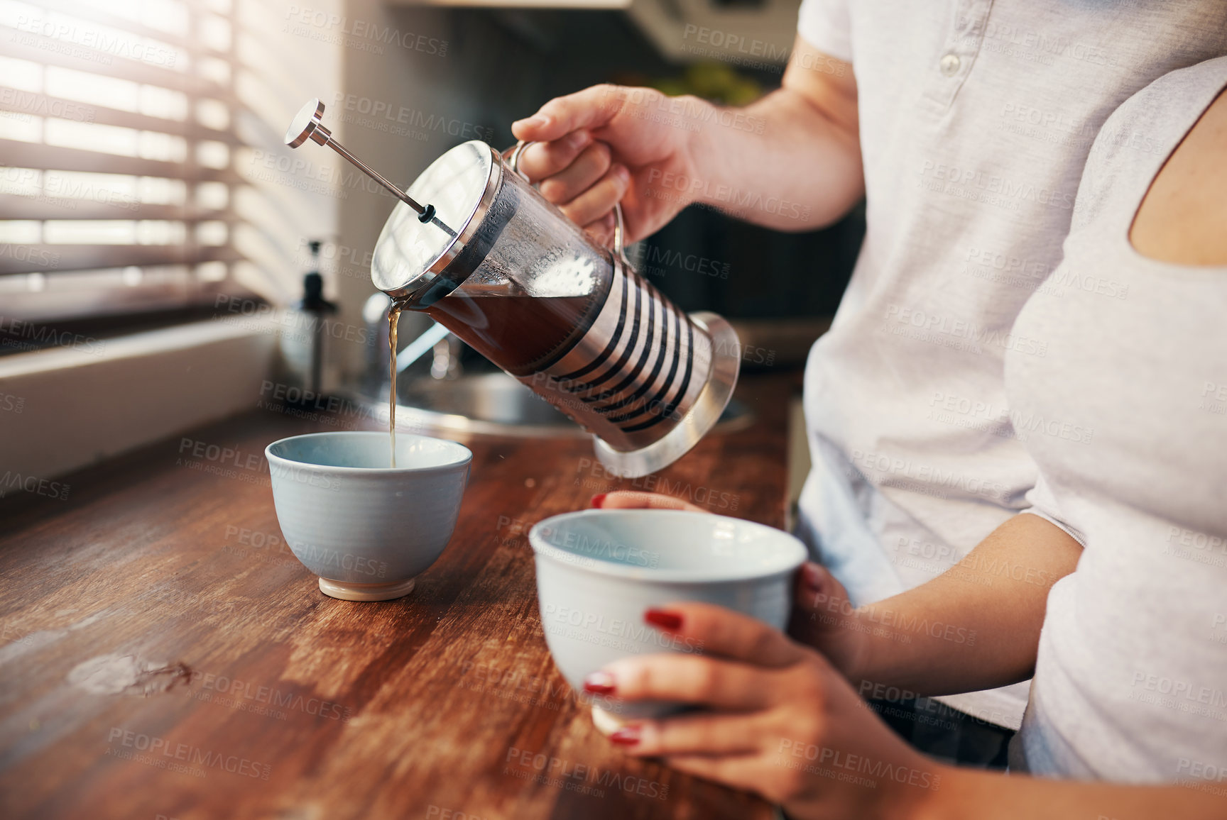 Buy stock photo Hands, french press and coffee for couple in kitchen with breakfast, bonding and start morning at apartment. People, drink and together with mug, love and connection with plunger in modern house