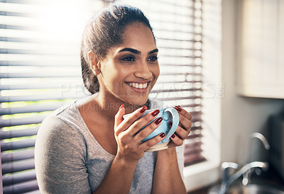 Buy stock photo Cropped shot of a beautiful young woman,enjoying a cup of coffee at home