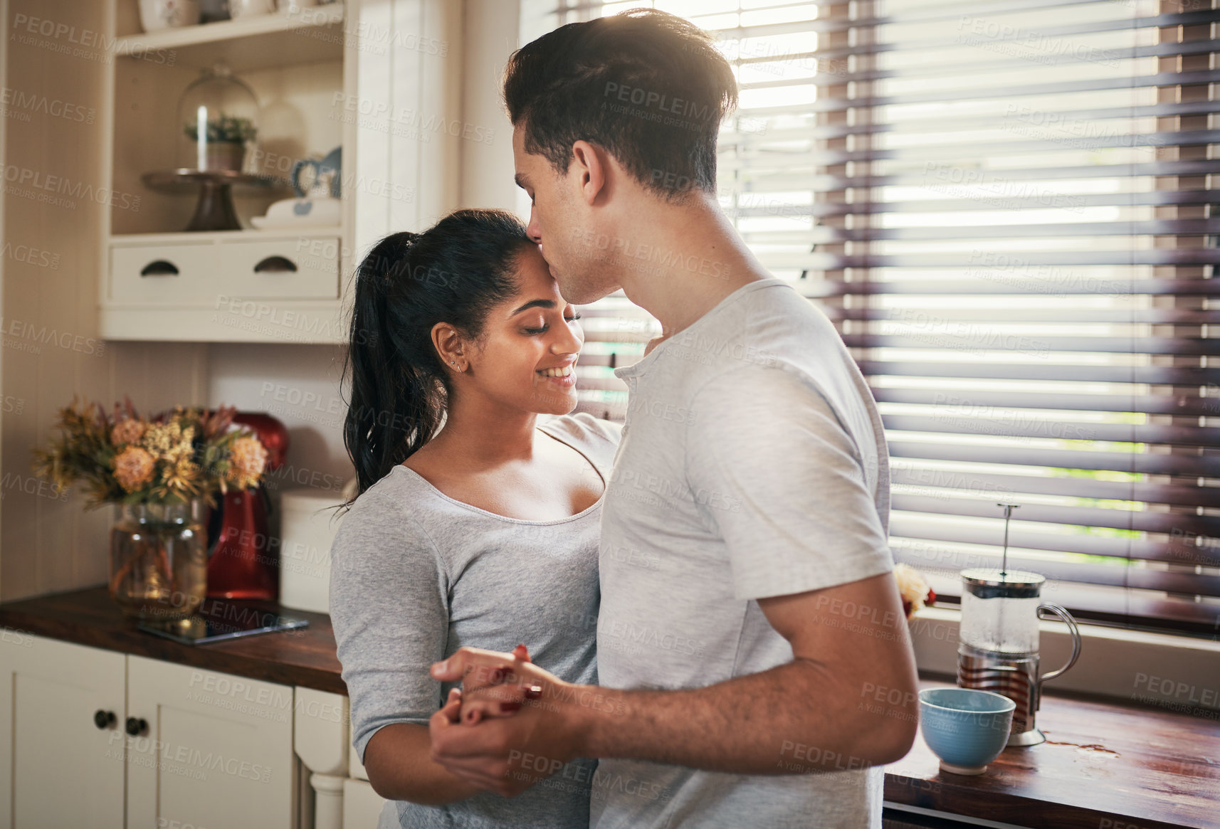Buy stock photo Cropped shot of a happy young couple slow dancing in their kitchen
