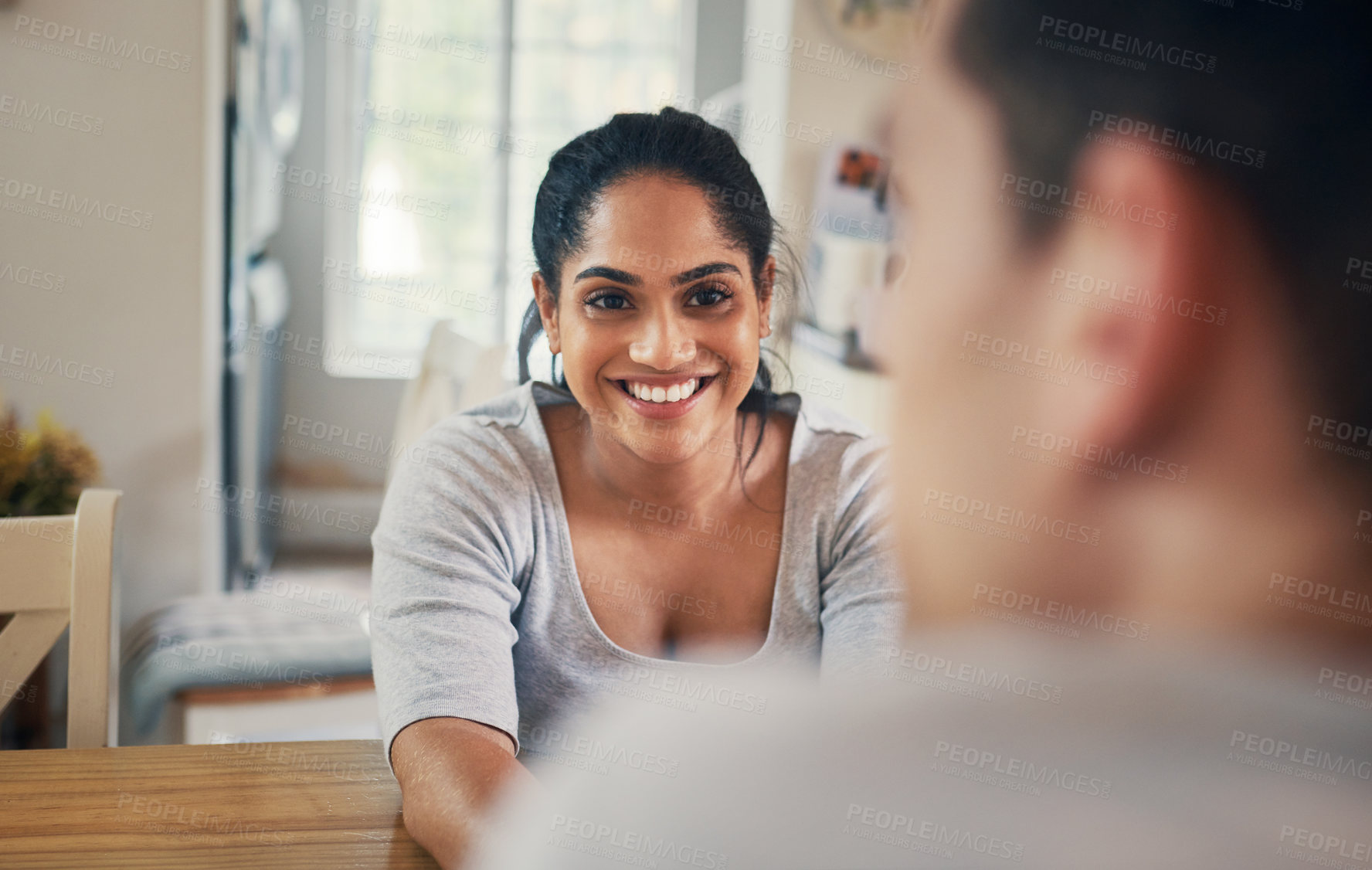 Buy stock photo Shot of a young woman sitting at home with her boyfriend