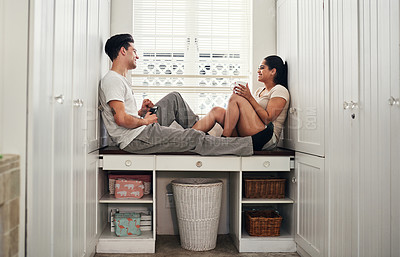 Buy stock photo Shot of a happy young couple sitting together at home
