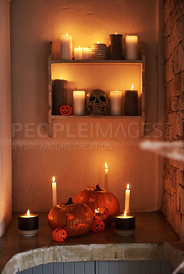 Buy stock photo Still life shot of carved pumpkins and lit candles placed together in celebration of halloween