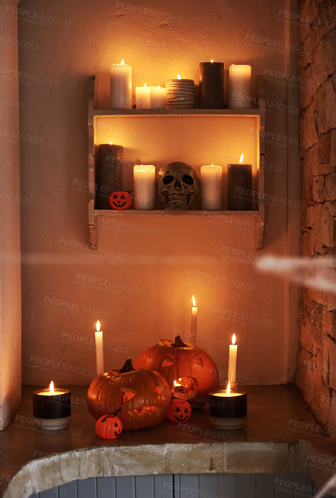 Buy stock photo Creative, decoration and holiday of Halloween in home with scary skull, pumpkin or candles. Creepy, celebration and shelf in house at night with traditional lantern for spooky party in festive season