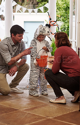Buy stock photo Shot of an adorable little boy celebrating halloween with his parents at home