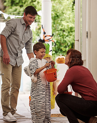 Buy stock photo Shot of two adorable little boys celebrating halloween with their parents at home