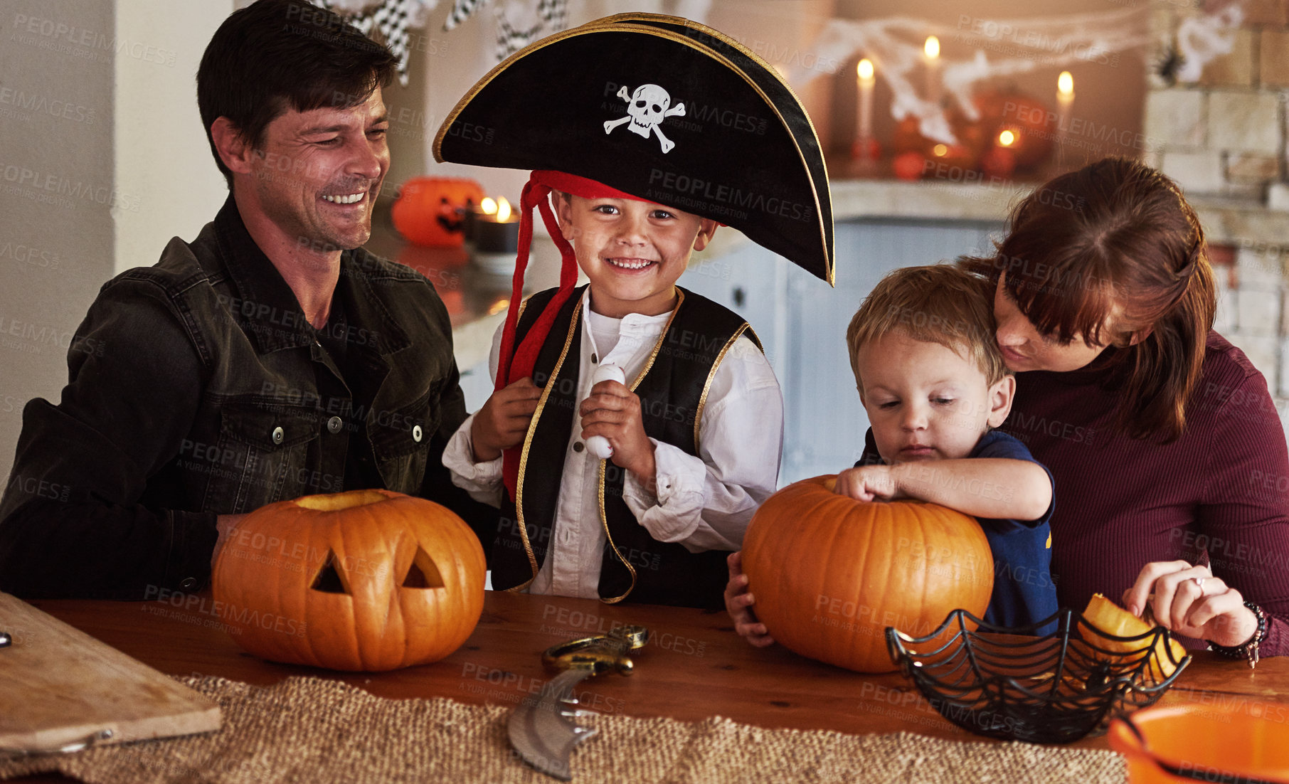 Buy stock photo Portrait of an adorable young boy dressed as a pirate celebrating Halloween with his family at home