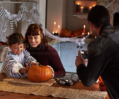 Buy stock photo Pictures, parents or kid with pumpkin for halloween to celebrate with smile, son or boy for fun. Home, man or woman with child carving face in vegetable for holiday lantern, decor or family memory