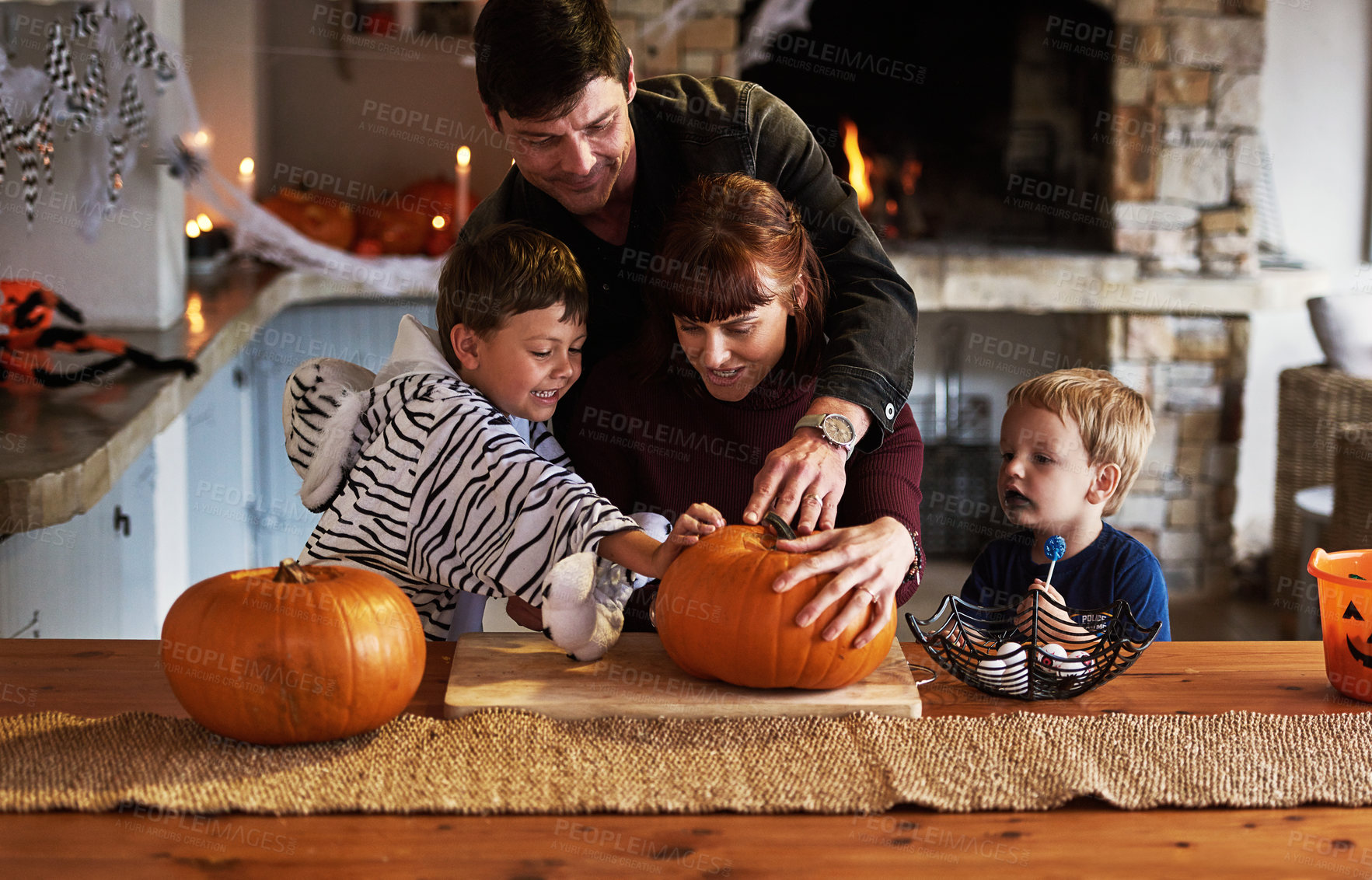 Buy stock photo Happy family, house and children with pumpkin for halloween to celebrate with siblings, parents or fun. Smile, mom or dad with kids carving face in vegetable for holiday lantern, decoration or party